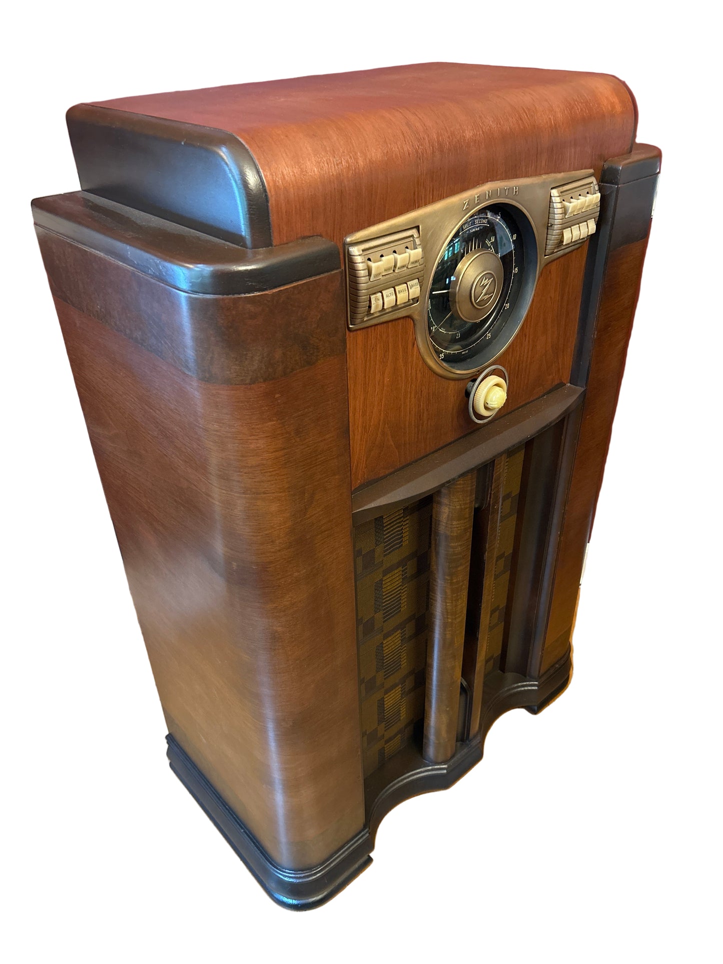 Vintage wooden radio on a wooden floor with a red wall in the background