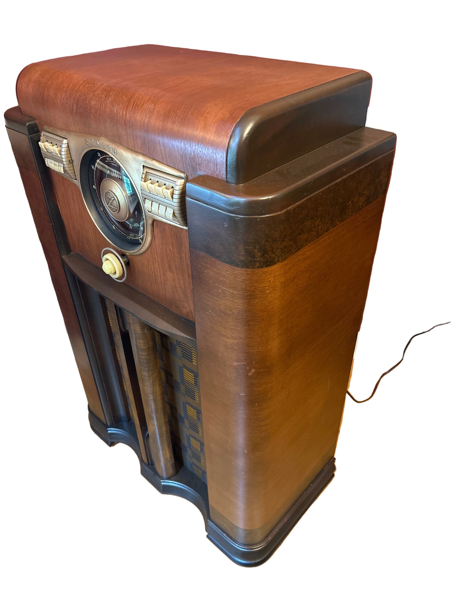 Vintage wooden radio on a wooden surface with a red wall in the background