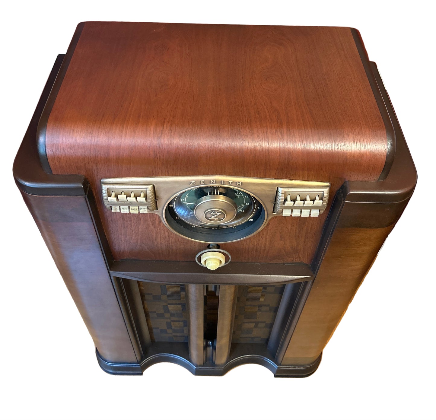 Vintage-style wooden radio on a wooden surface with a red wall background