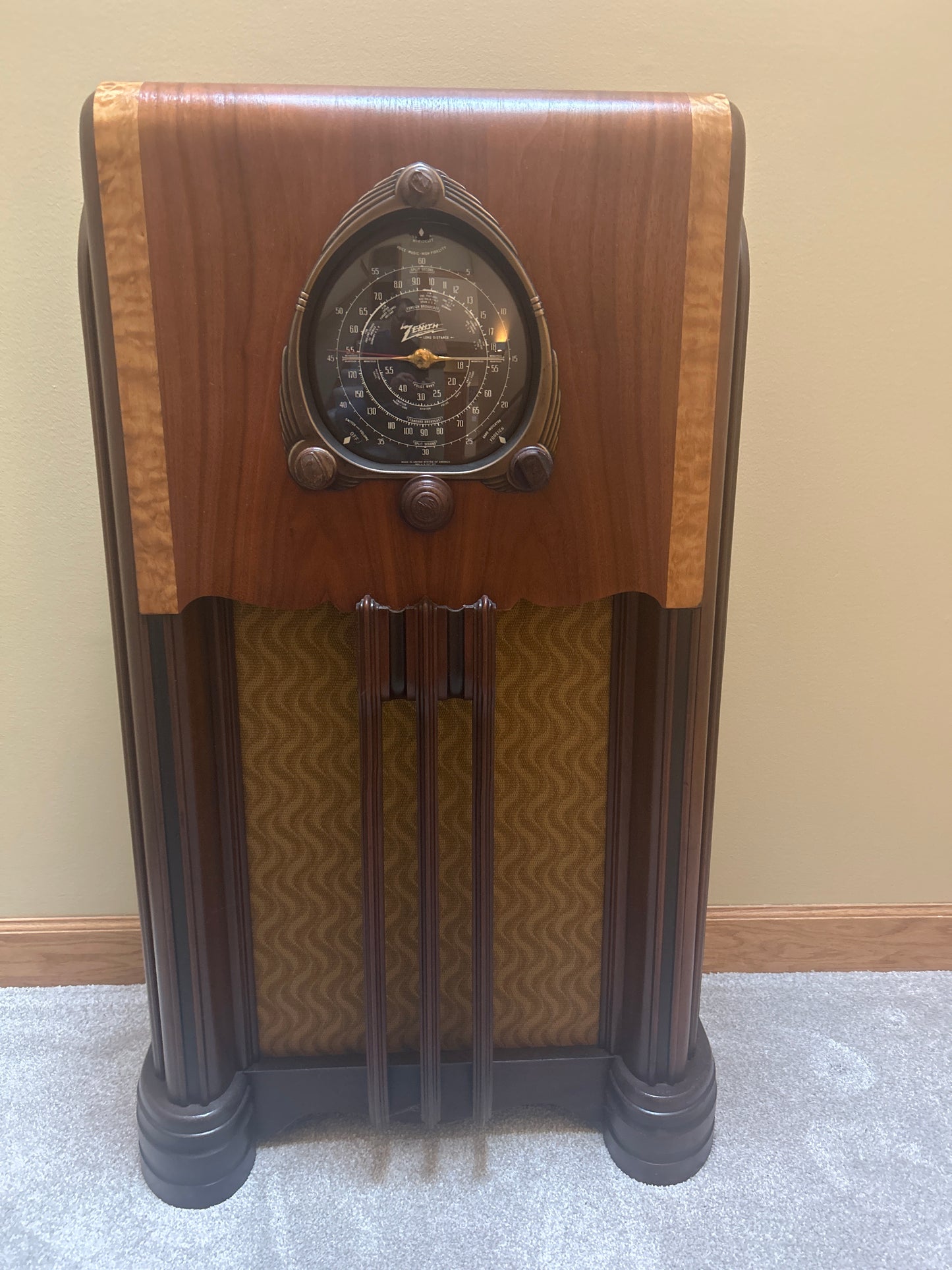 A fully restored 1938 Zenith Amp and Radio console featuring a glossy black dial, wood knobs, and a vintage push-pull speaker, elegantly refinished to highlight its mid-century modern design.