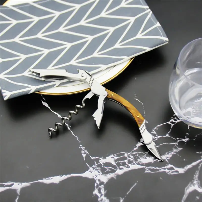 Corkscrew with wooden handle on a marble surface