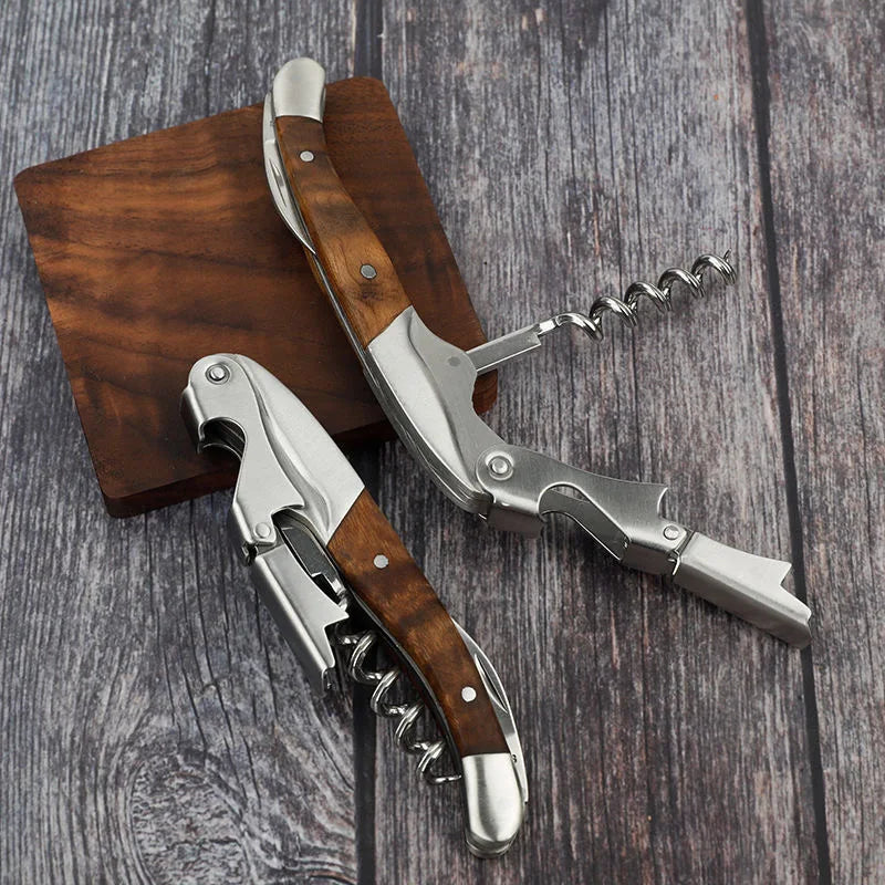 Two corkscrews with wooden handles on a wooden surface