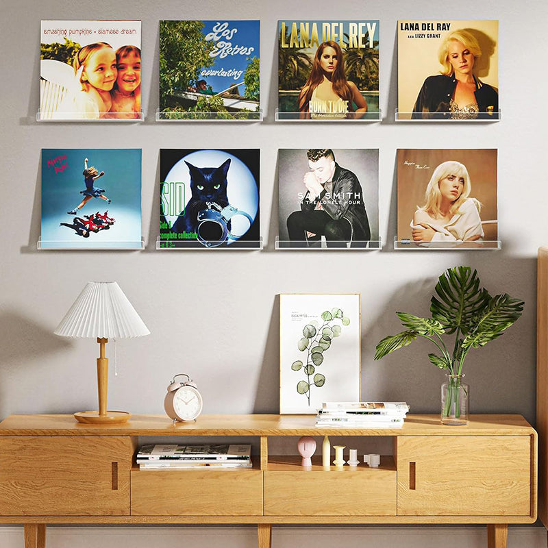 Clear plastic vinyl record display shelf, designed for wall-mounted storage and showcasing LPs, 12-inch, and 7-inch records in a sleek, modern style.