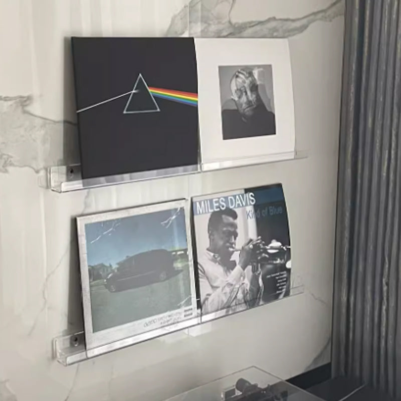 Clear plastic vinyl record display shelf, designed for wall-mounted storage and showcasing LPs, 12-inch, and 7-inch records in a sleek, modern style.