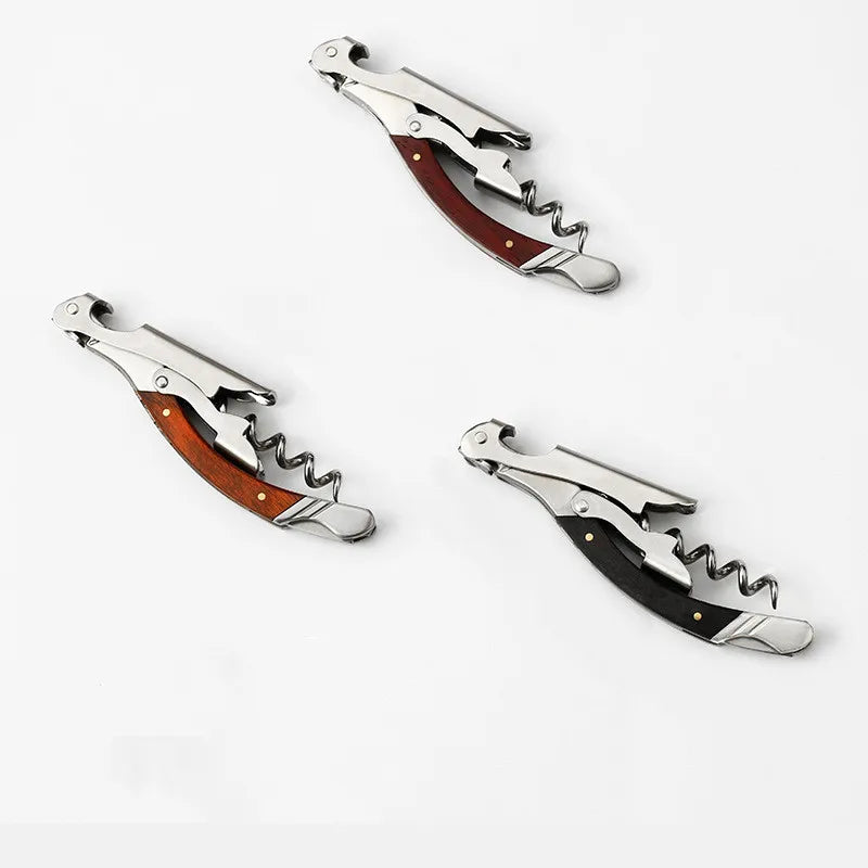 Three corkscrews with wooden handles on a white background