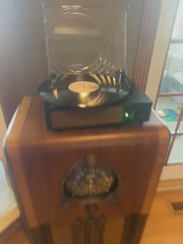 Video of a fully restored 1938 Zenith Amp and Radio console featuring a glossy black dial, wood knobs, and a vintage push-pull speaker. Designed for hi-fi performance and record player compatibility, this elegant mid-century modern cabinet offers warm, authentic tones for music enthusiasts.