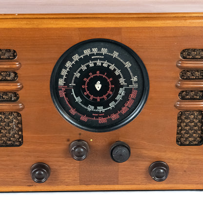 Close-up of a vintage radio with wooden casing and dial