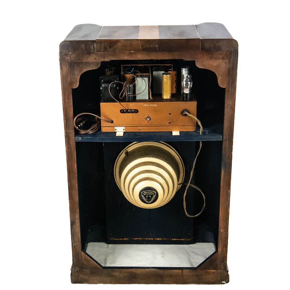 Vintage wooden radio cabinet with a round speaker and control panel on a white background