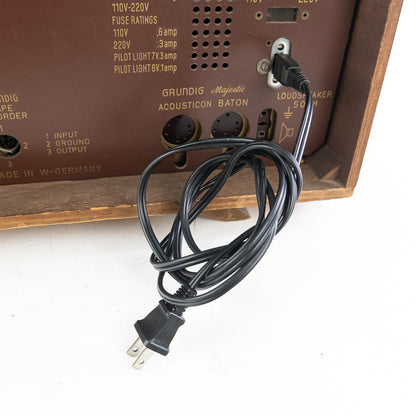 Vintage Grundig radio with power cord on a white background