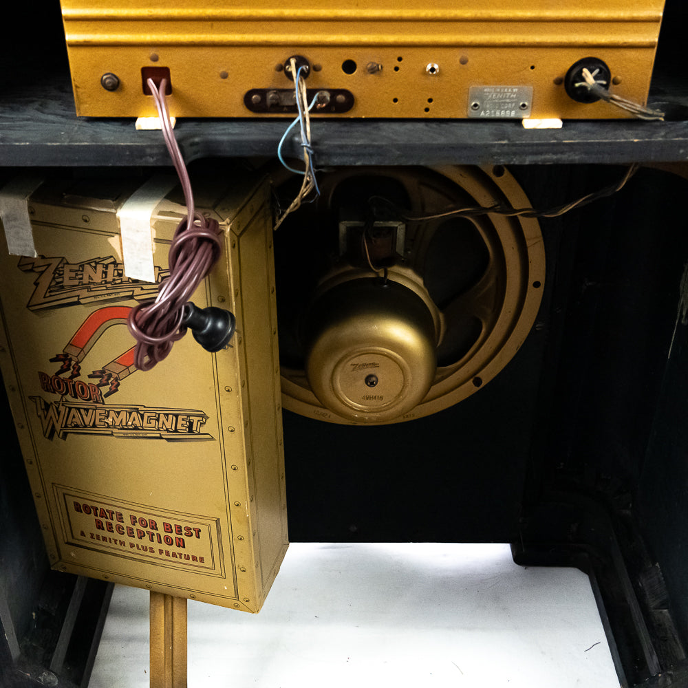 Vintage-style gold machine with branding on a dark background