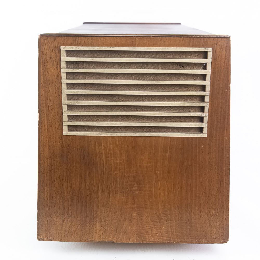Wooden speaker with metallic grille on a white background