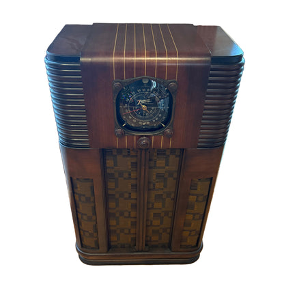 Vintage wooden radio on a wooden floor with a window in the background