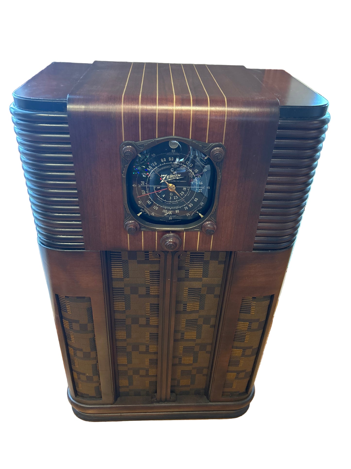 Vintage wooden radio with decorative patterns on a wooden floor.