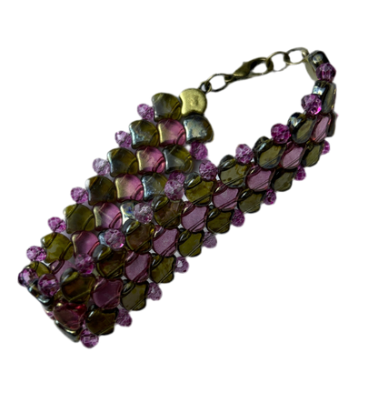 Bracelet with green and purple beads on a white background