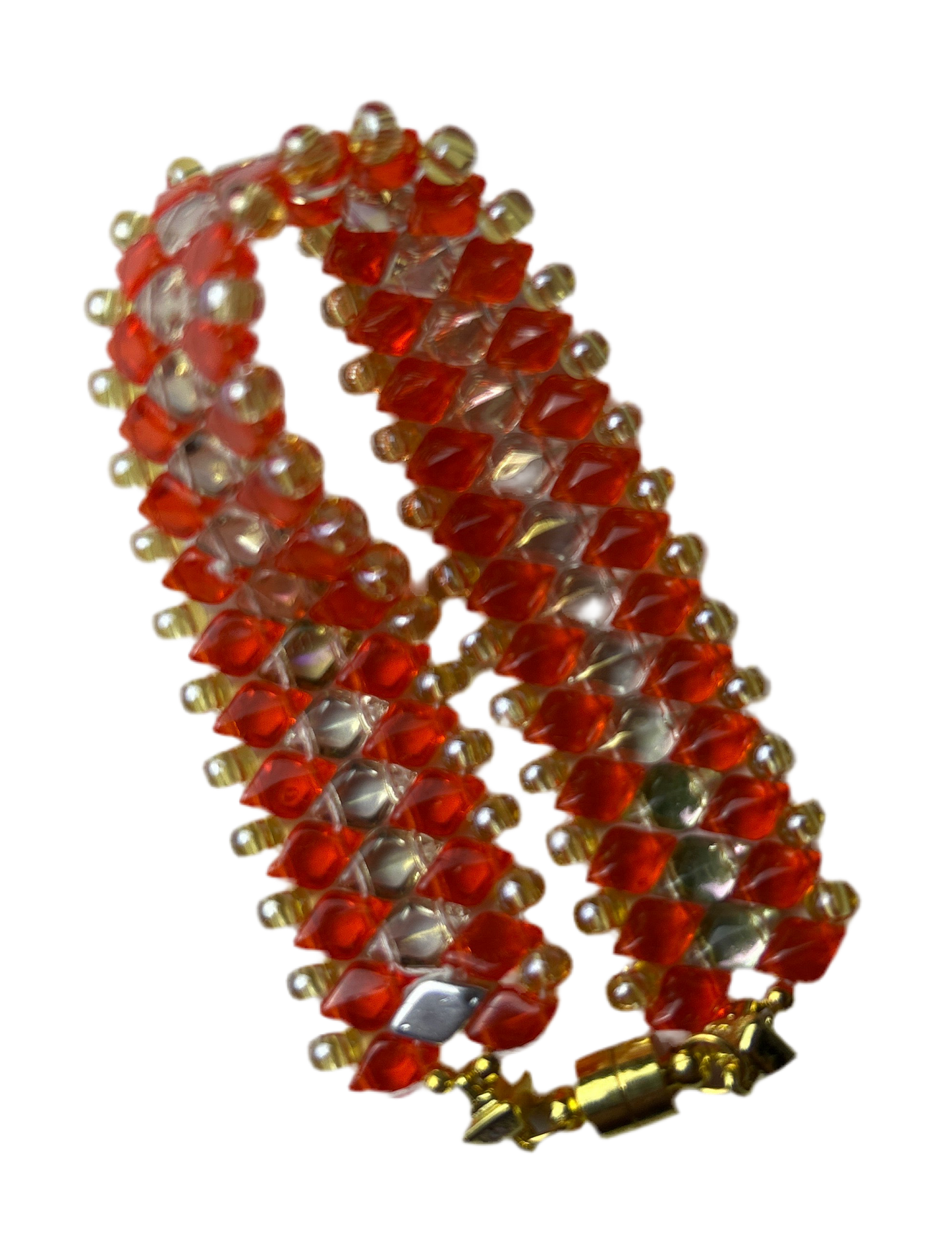 Decorative red and gold spiral object on a white background