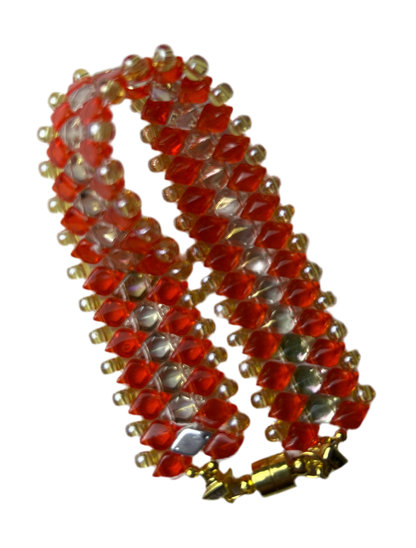 Decorative red and gold spiral object on a white background