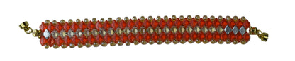 Beaded bracelet with orange beads and gold accents on a gray background