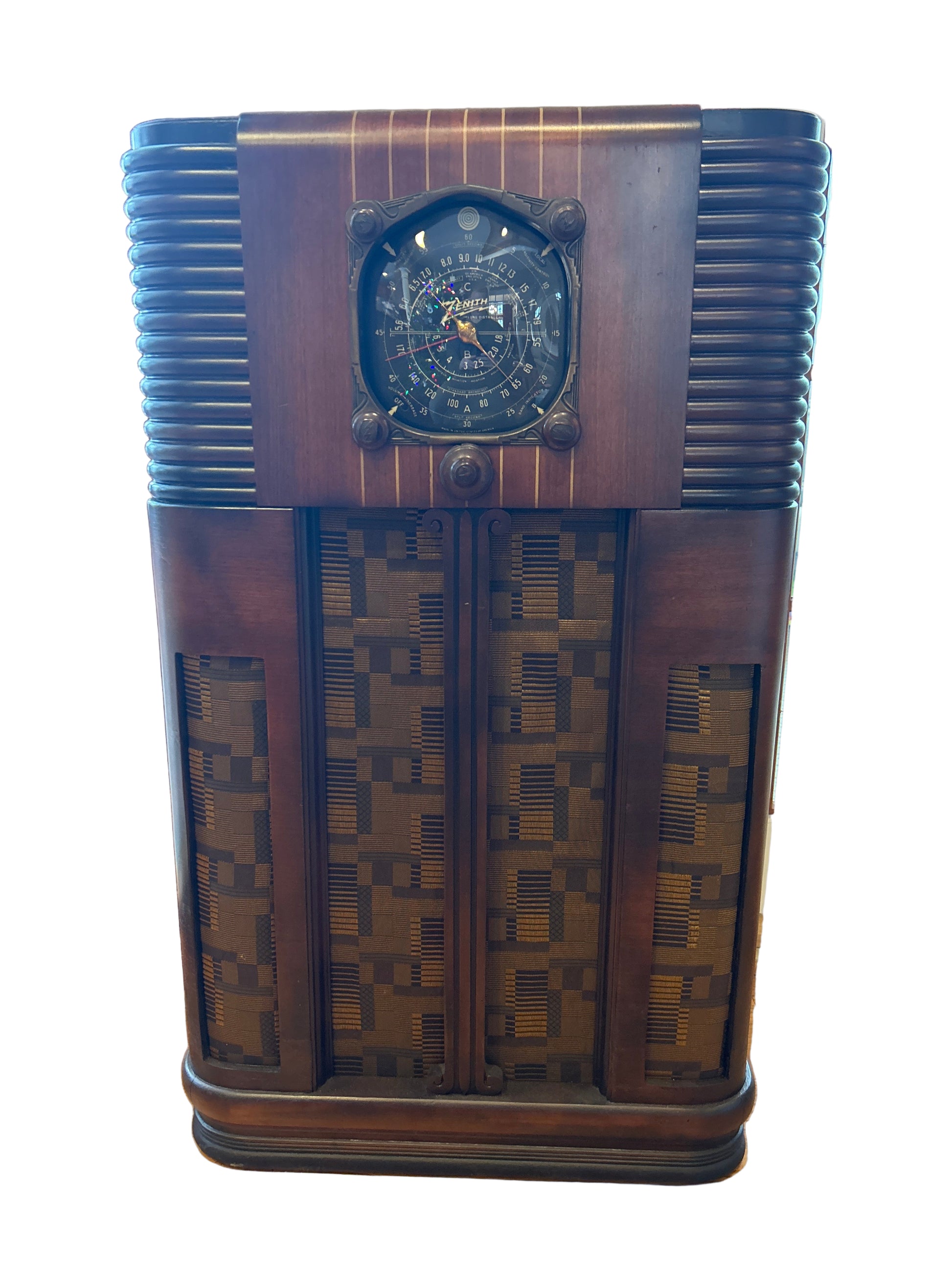 Vintage wooden radio on a wooden surface with a window in the background