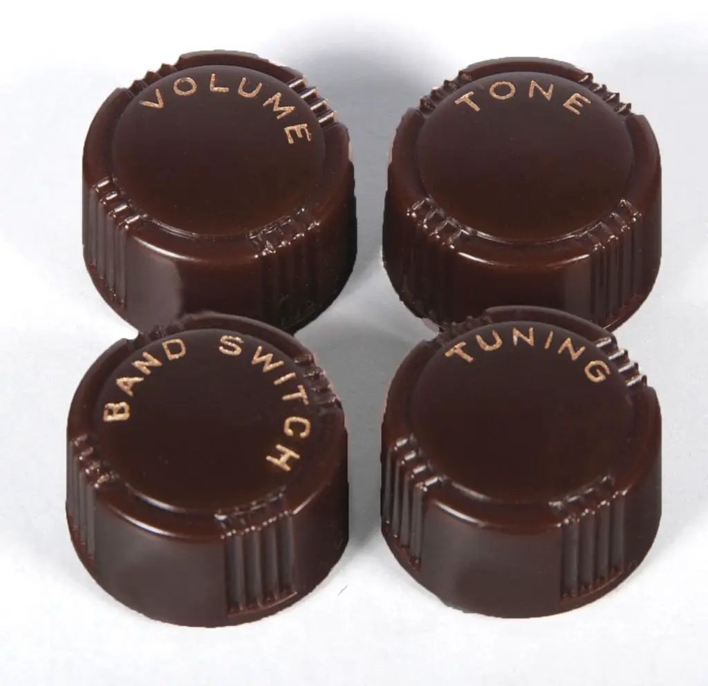 Set of four reproduction radio knobs with inscribed function labels, Grunow and Truetone style