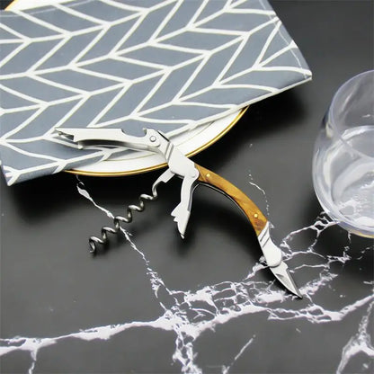 Corkscrew with wooden handle on a marble surface