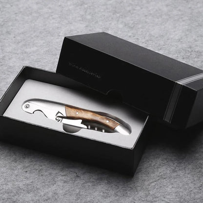 Corkscrew with wooden handle in a black box on a gray background