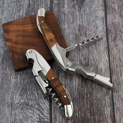 Two corkscrews with wooden handles on a wooden surface