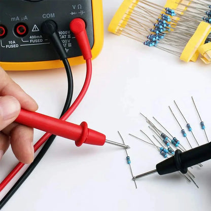 Multimeter probes being used with a set of resistors on a white background
