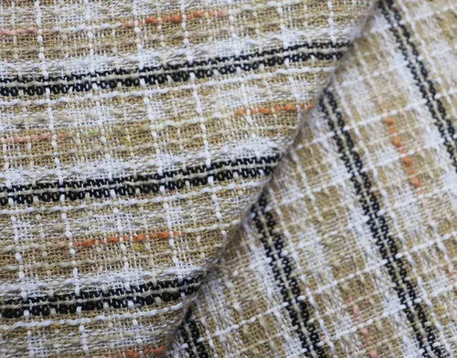 Close-up of textured fabric with a checkered pattern, showing colors like brown, black, and beige.