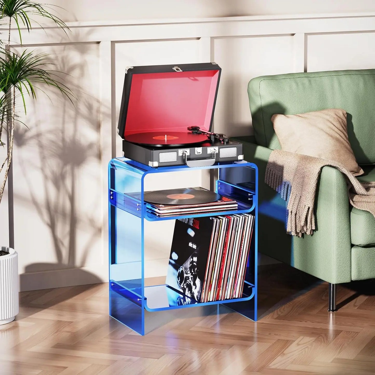 Minimalist blue acrylic turntable table with organized vinyl storage.